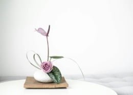 green and white ceramic vase on brown wooden table